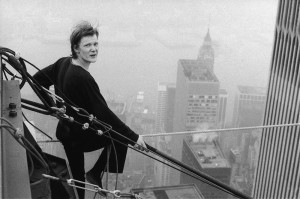 French tightrope walker Philippe Petit, 24, looks back at the photographer as he rests between walks across a cable stretched between New Yorkís World Trade Center towers high above the city on Wednesday, August 7, 1974. Petit crossed the cable twice and at one point, hung by his heels. The Frenchman and two assistants apparently hid in one of the towers and set the cable up before dawn, police said. (AP Photo/Alan Welner)